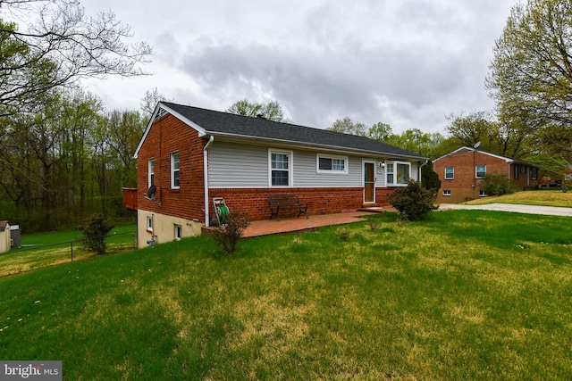 single story home featuring fence, a front lawn, and brick siding