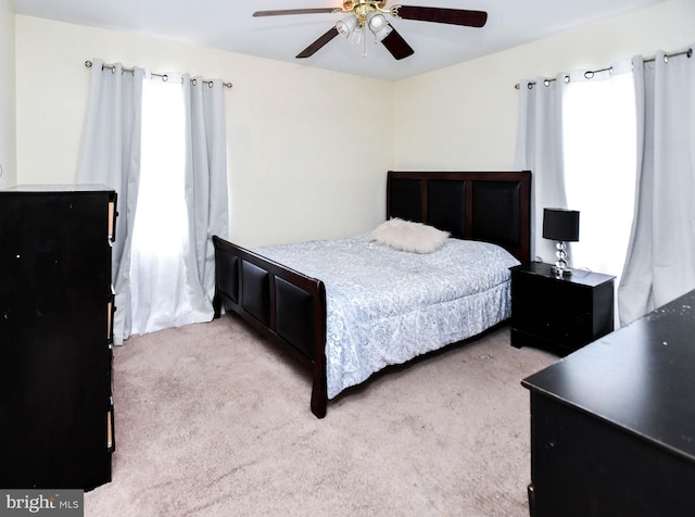 carpeted bedroom with a ceiling fan
