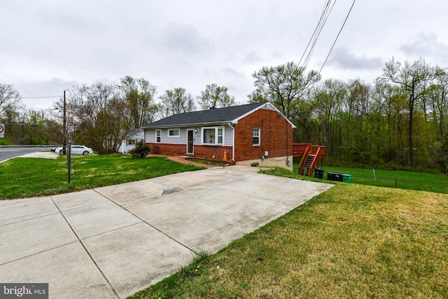 exterior space featuring a front yard and brick siding
