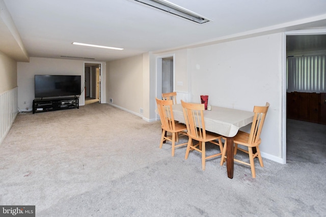 dining area with baseboards and carpet flooring