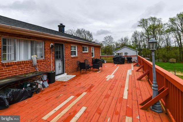 wooden deck featuring area for grilling