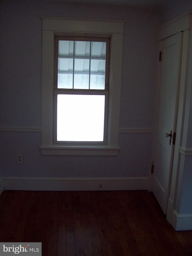 spare room with wood finished floors