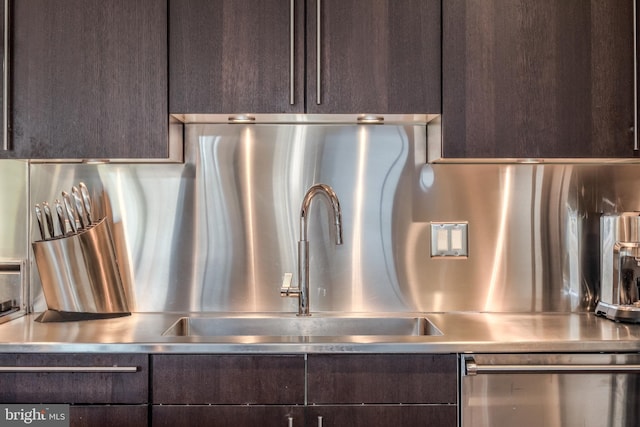 interior details with stainless steel countertops, stainless steel dishwasher, and dark brown cabinets