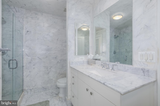full bath featuring a marble finish shower, toilet, marble finish floor, and vanity