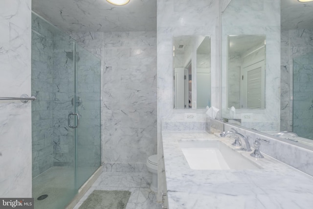 full bath with vanity, a marble finish shower, tile walls, toilet, and marble finish floor