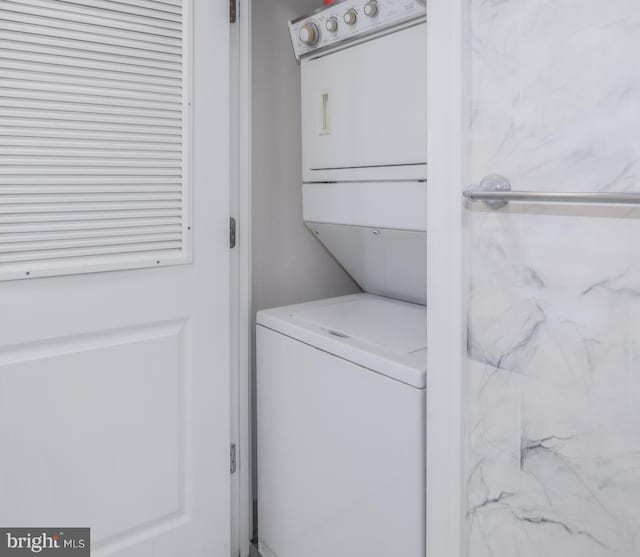laundry area featuring laundry area and stacked washer / dryer