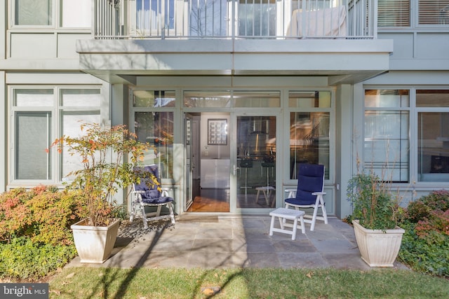 property entrance featuring a patio area and a balcony