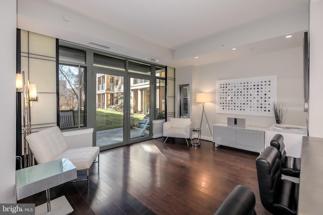 living area with recessed lighting, wood finished floors, and baseboards