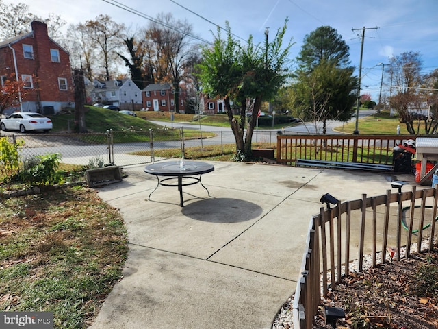 view of patio with a residential view and fence