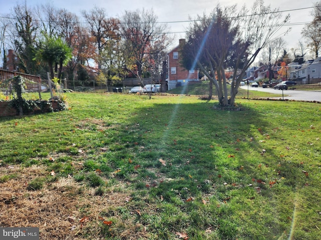 view of yard with a residential view and fence