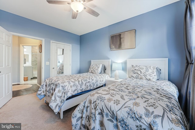 bedroom featuring carpet flooring, ensuite bathroom, and ceiling fan