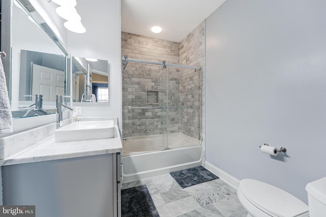 bathroom with vanity, baseboards, bath / shower combo with glass door, toilet, and marble finish floor