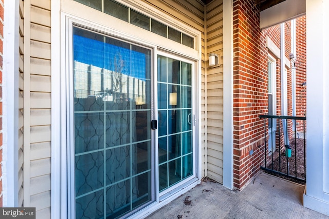 property entrance featuring brick siding