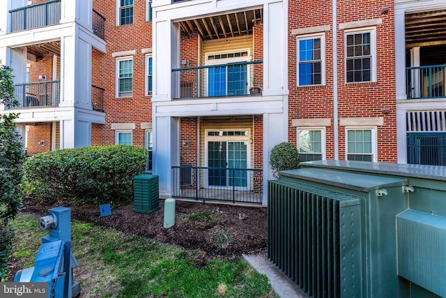 view of exterior entry featuring brick siding