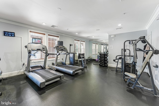 exercise room featuring visible vents, crown molding, and baseboards