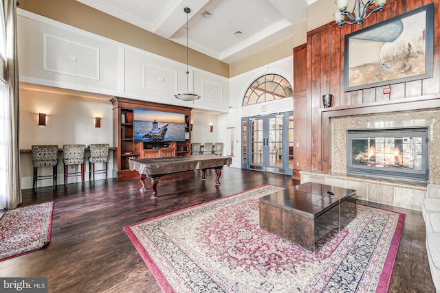 living room with ornamental molding, french doors, a fireplace, wood finished floors, and billiards