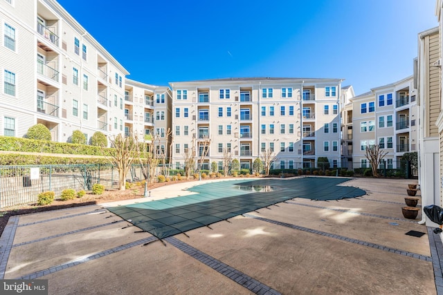 community pool featuring a patio and fence