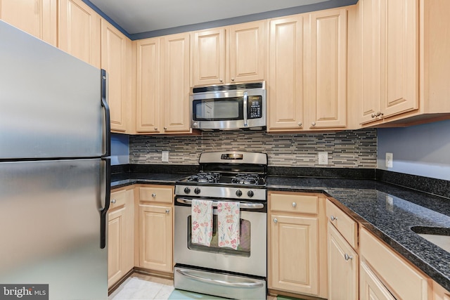 kitchen with light brown cabinetry and appliances with stainless steel finishes