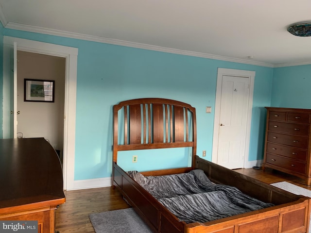 bedroom featuring ornamental molding, baseboards, and dark wood-style flooring