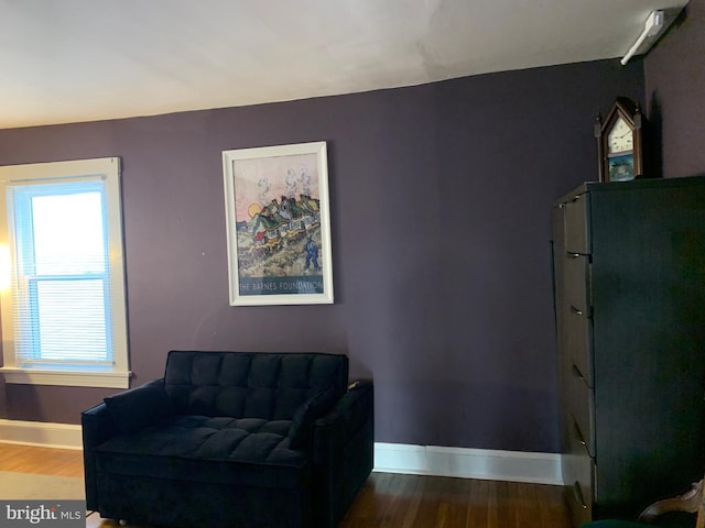 sitting room featuring baseboards and wood finished floors