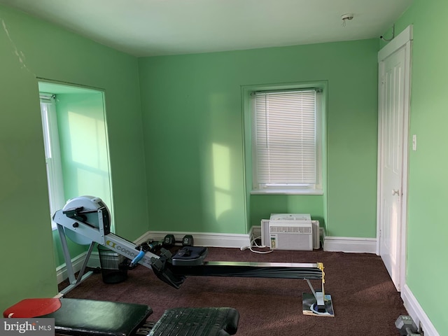 workout room with carpet flooring, baseboards, and a wall mounted AC