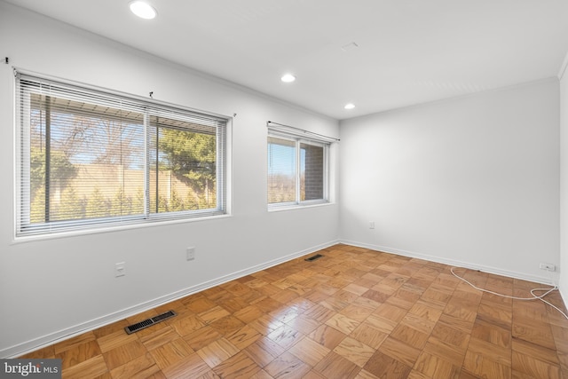 spare room with recessed lighting, baseboards, and visible vents