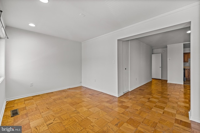 spare room with recessed lighting, baseboards, and visible vents