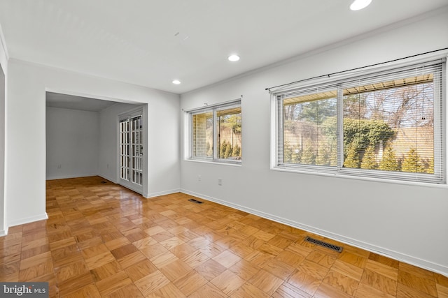 spare room featuring recessed lighting, visible vents, and baseboards