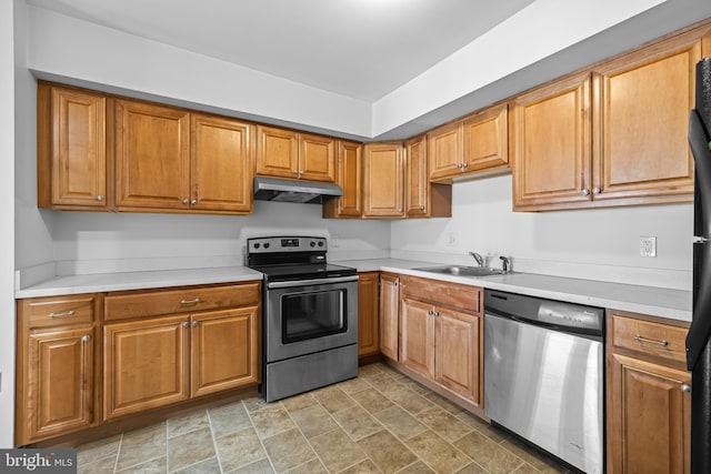 kitchen featuring a sink, stainless steel appliances, light countertops, under cabinet range hood, and brown cabinets