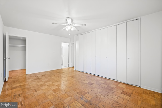 unfurnished bedroom with a closet, baseboards, and a ceiling fan