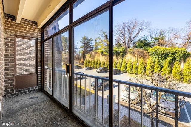 unfurnished sunroom with beam ceiling