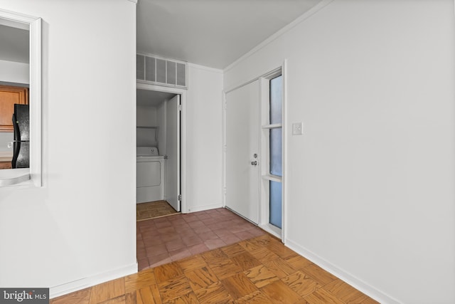 hall featuring tile patterned floors, visible vents, ornamental molding, washer / clothes dryer, and baseboards