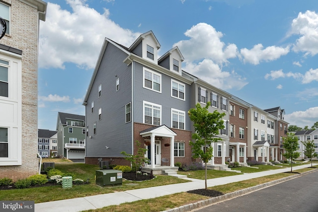 view of front facade featuring brick siding and a residential view