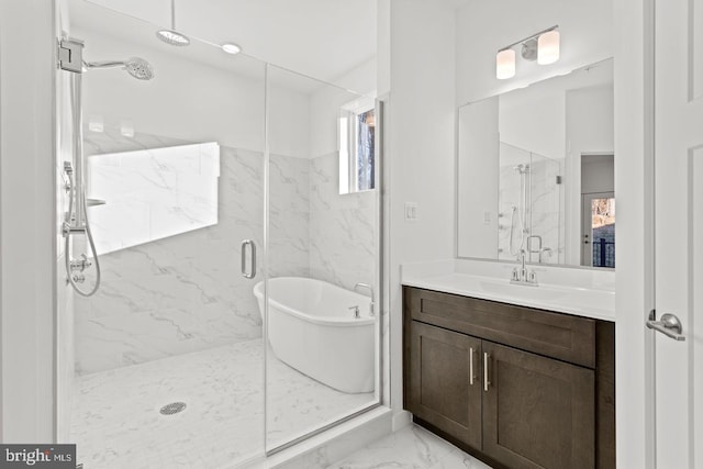 bathroom with vanity, a freestanding tub, marble finish floor, and a marble finish shower