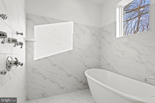 bathroom with a freestanding tub, tiled shower, and tile walls