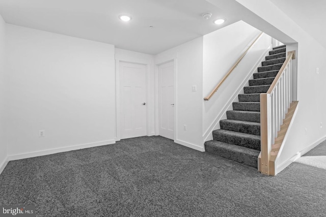 below grade area with stairway, carpet flooring, recessed lighting, and baseboards