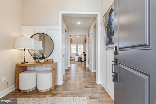 foyer with light wood-style flooring, recessed lighting, and baseboards