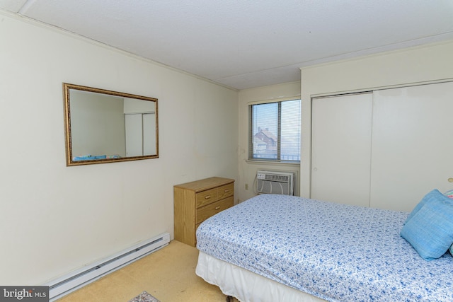 carpeted bedroom with a closet, baseboard heating, and an AC wall unit