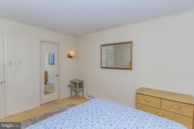 bedroom with light colored carpet and a baseboard radiator