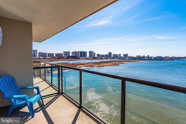 balcony with a view of city and a water view