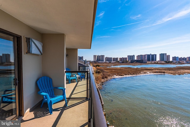 balcony featuring a city view and a water view