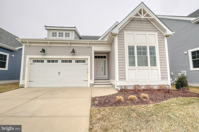 view of front of house featuring concrete driveway and a garage