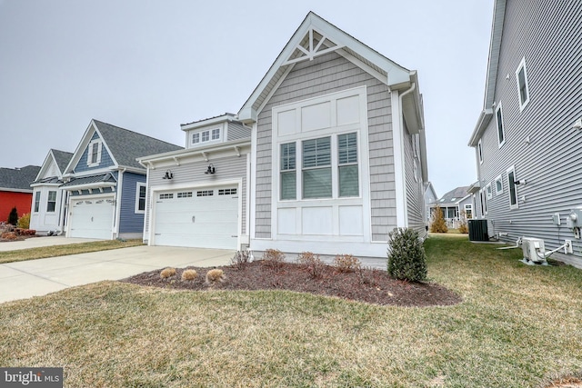 view of front of home with a garage, cooling unit, concrete driveway, and a front yard