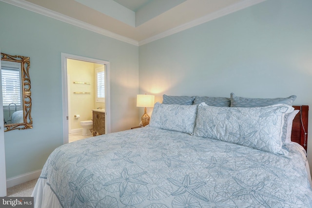 bedroom with carpet flooring, ensuite bath, baseboards, and ornamental molding