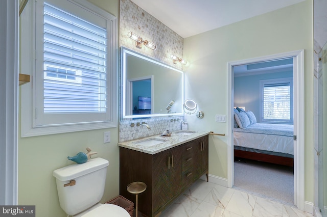 ensuite bathroom featuring ensuite bath, double vanity, a sink, decorative backsplash, and marble finish floor