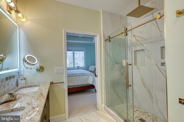 ensuite bathroom featuring marble finish floor, ensuite bath, a marble finish shower, baseboards, and vanity