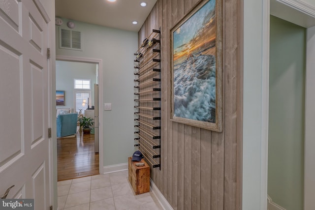 hallway featuring recessed lighting, visible vents, baseboards, and light tile patterned flooring