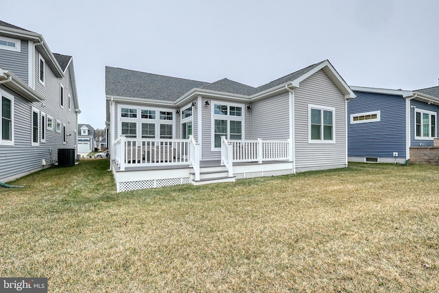 back of property with central air condition unit, a wooden deck, and a yard