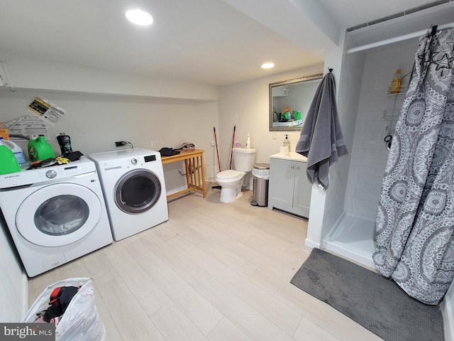 clothes washing area with recessed lighting, laundry area, independent washer and dryer, and light wood-type flooring