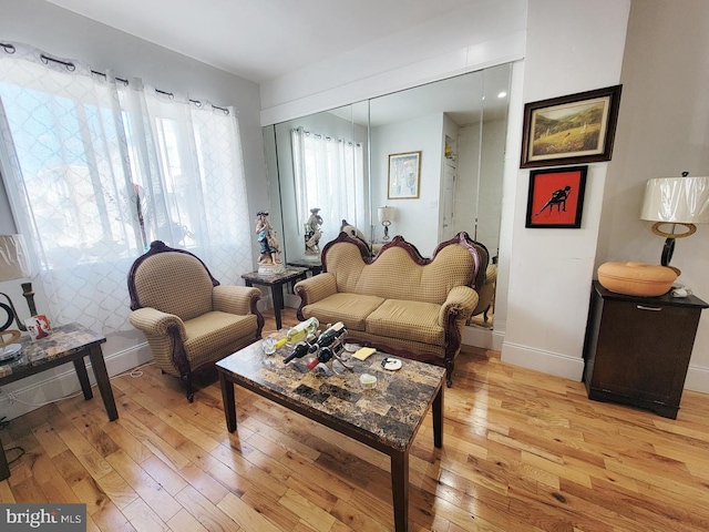 living area with baseboards and light wood-type flooring